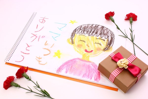 Japanese children celebrates Mother's Day while giving their moms bouquets or single red carnations